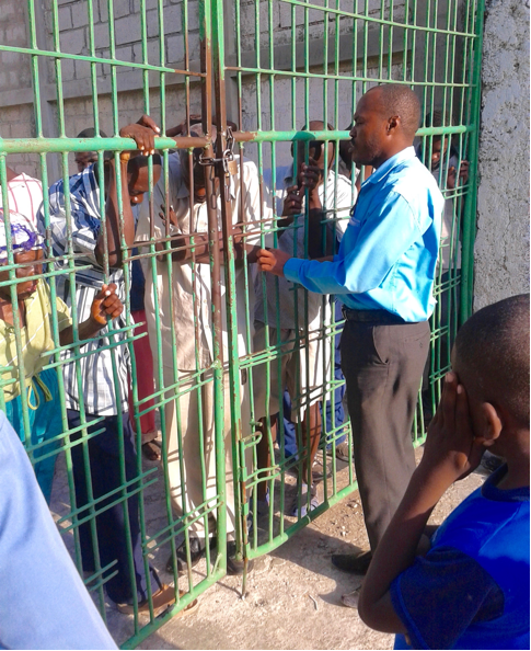 Pastori rukoilee vankien kanssa portilla sekä jakaa leipää.